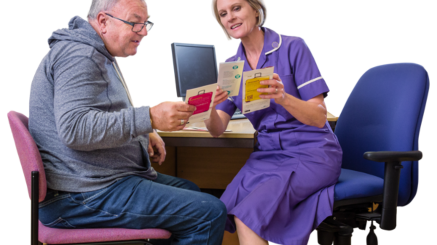 A learning disability nurse is helping a patient read a leaflet