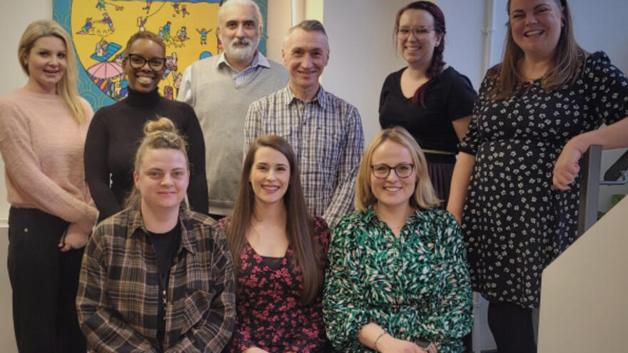An image of all the members of the community engagement team, from the Network Office, posing and smiling together.