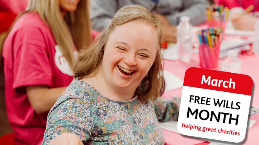 A woman with Down syndrome is sitting at a table smiling at the camera, next to her picture is the FREE Wills Month logo