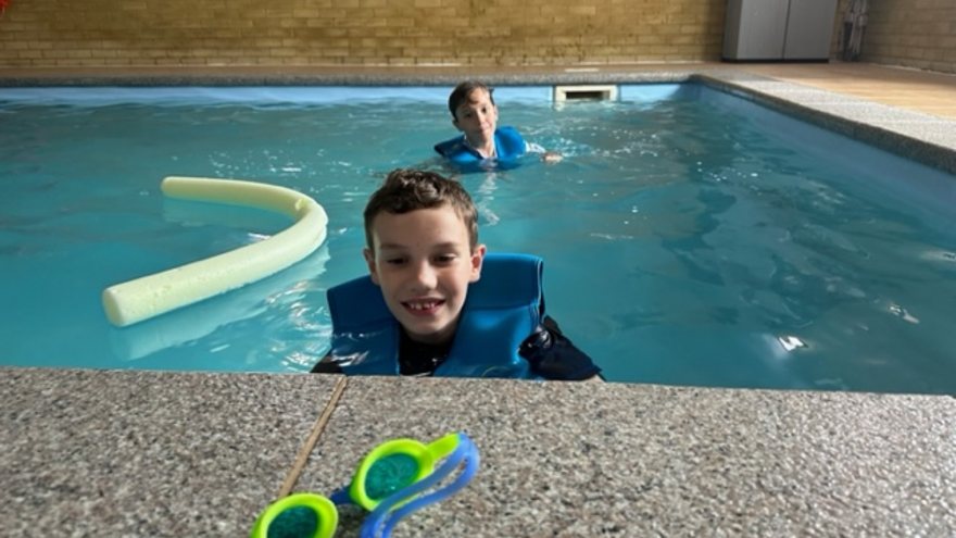 A photograph of Lawrence in the swimming pool