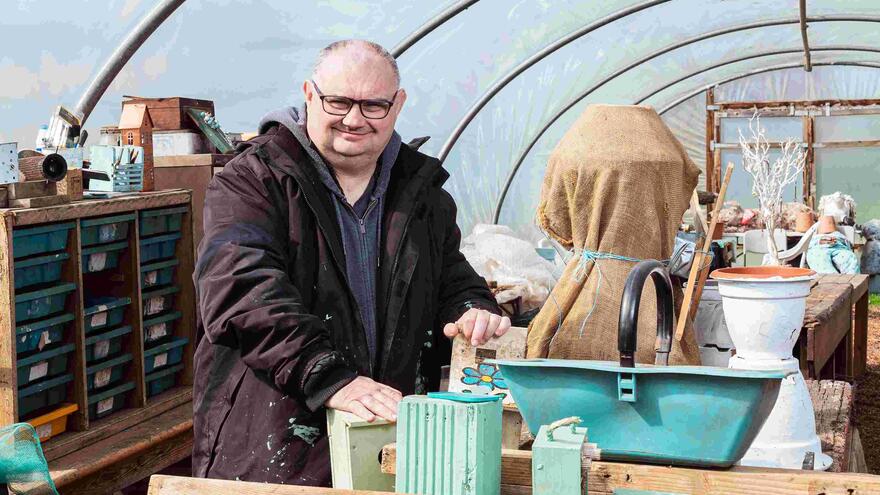 Darren in a polytunnel gardening