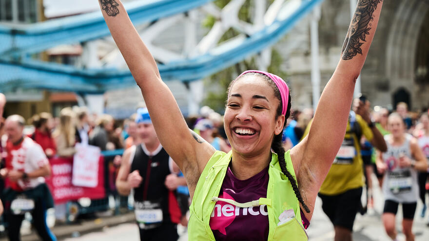 A female runner cheering in the crowds