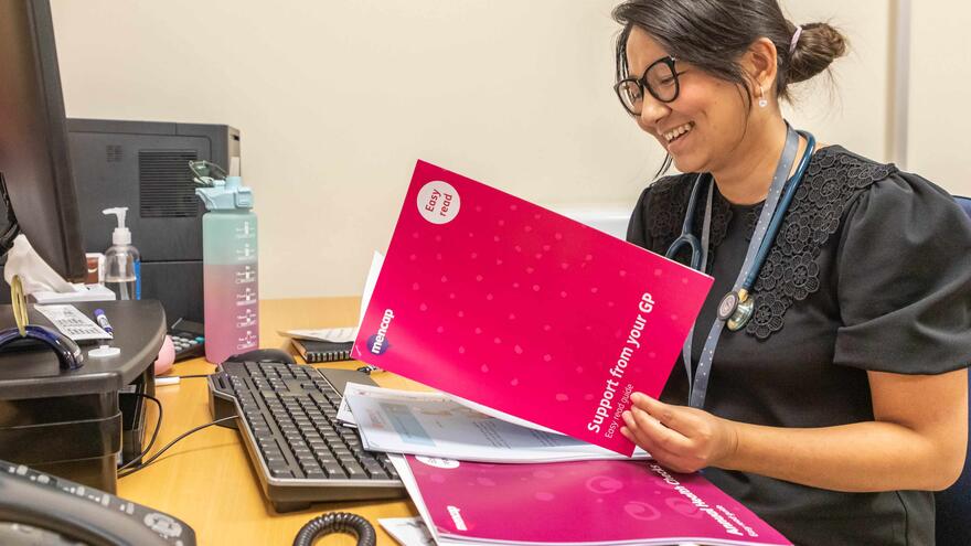 Doctor reading an Easy Read leaflet