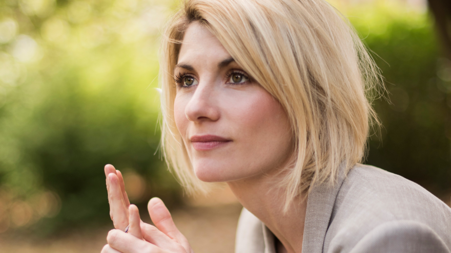 A close up of Jodie sitting in a park