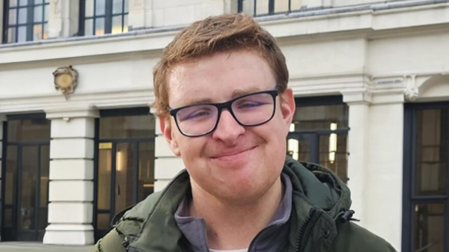 A head and shoulders picture of Dan outside a stone building