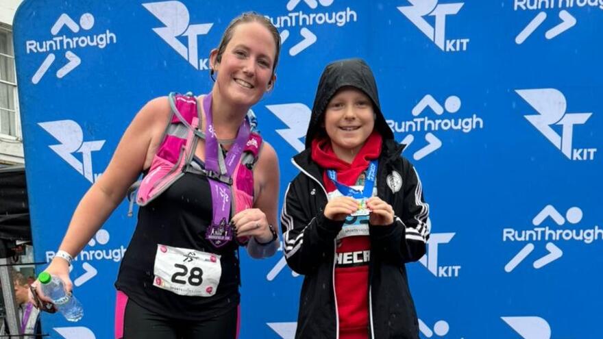 Logan with his mum Lucy on a winners podium