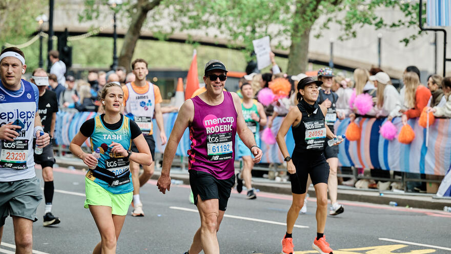 Runner wearing a Mencap Vest and smiling