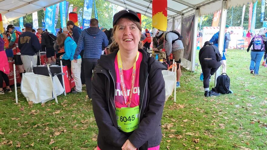 Gina standing in a tent where people are preparing for the challenge