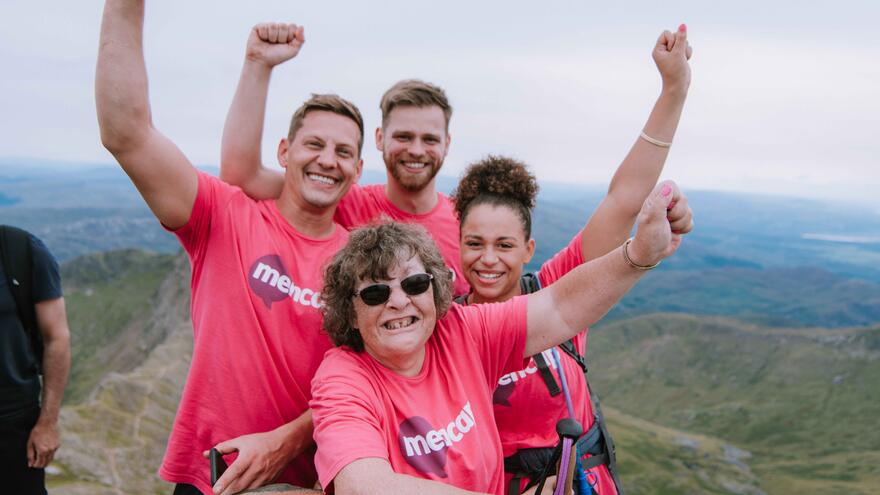4 Mencap supporters cheering and smiling 