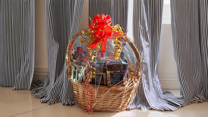 Hamper wicker basket on floor in front of curtains