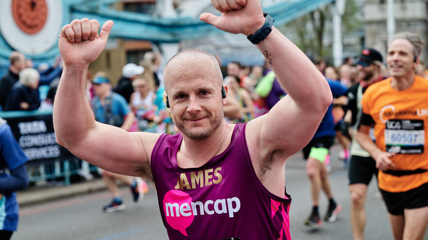 Mencap runner waving and smiling