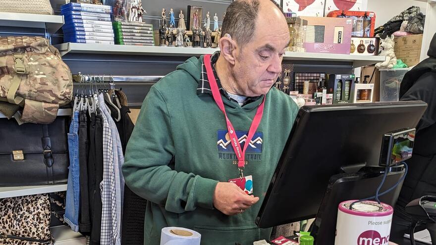 Daran on the till at the Clifton Mencap shop