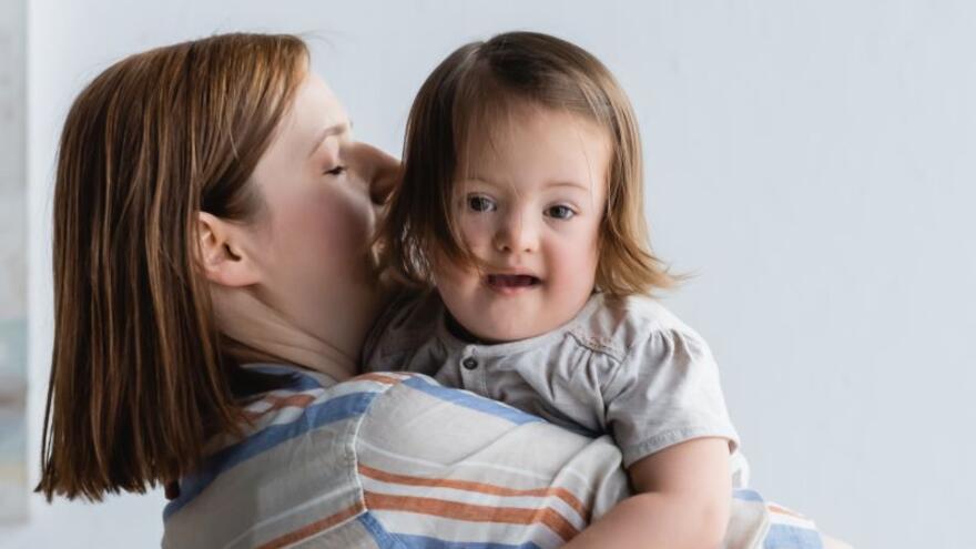 A mother holding a child with a learning disability