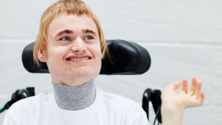 A head and shoulders photograph of Alistair - a Mencap mythbuster who has Angelman syndrome