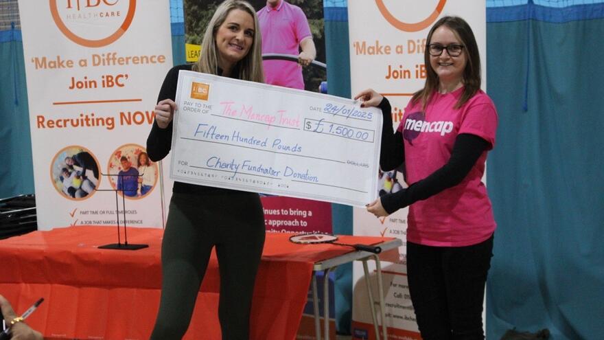 Cheque for £1,500 being presented to Mencap by IBC Healthcare