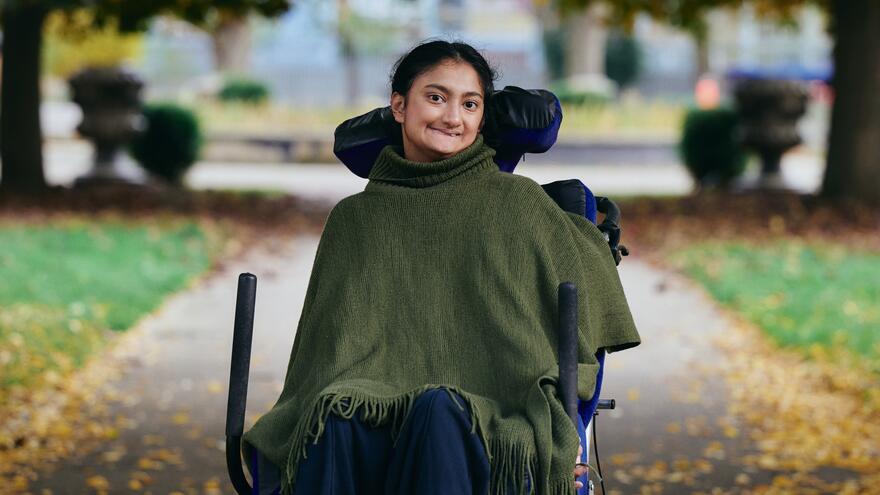 Rahima smiling in a park 