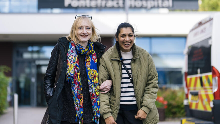 Surekah and a companion walking out of a hospital
