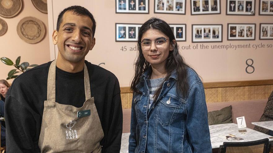 Supported internship learner, Zaki standing with Natalie during their interview. They are both smiling.