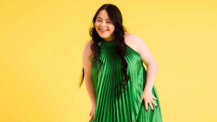 Ellie Goldstein in a green dress