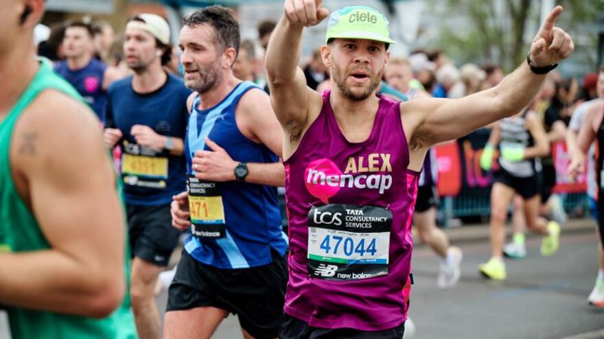 A marathon runner in a Mencap running vest