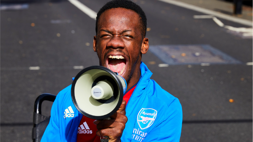 Brendan campaigning outside with a megaphone. 