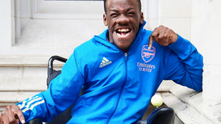 A photograph of Brendan in his Arsenal tracksuit
