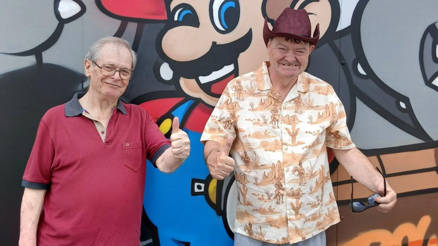 Two men with their thumbs up