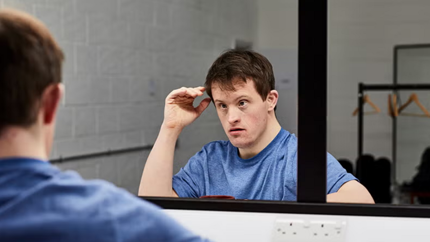 Tommy Jessop looking in a mirror