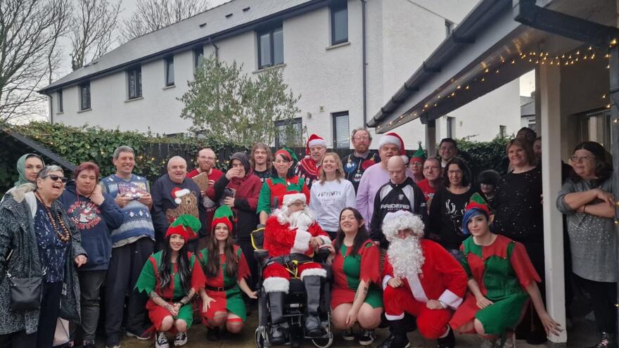 Group of staff and people we support in christmas accessories