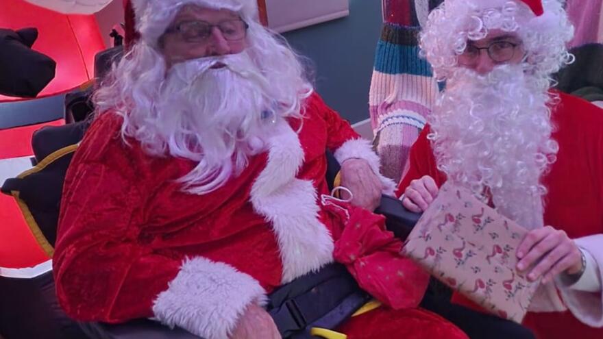 Two people dressed as santa