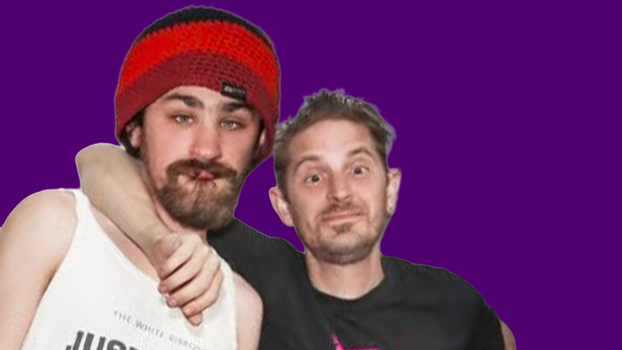 Two men looking at the camera. One man has his arm around the other man's shoulders