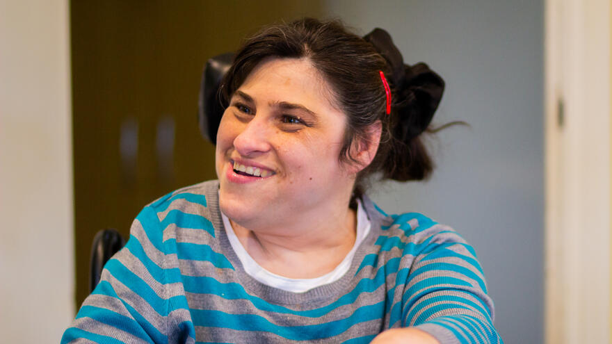 Person with learning disability in wheelchair smiling