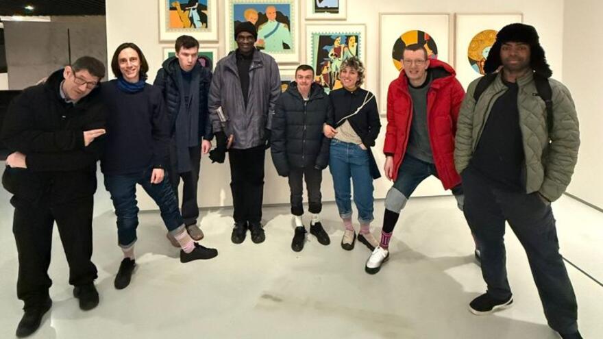 A group of people in an art exhibition room