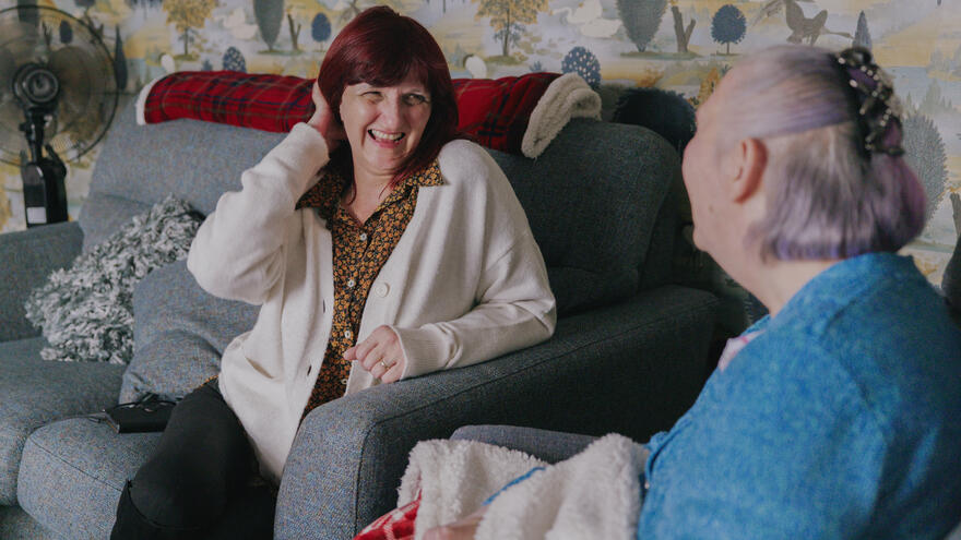 Tracy Welford, a Mencap Area Operations Manager in South Yorkshire is sitting having a conversation with a service user.