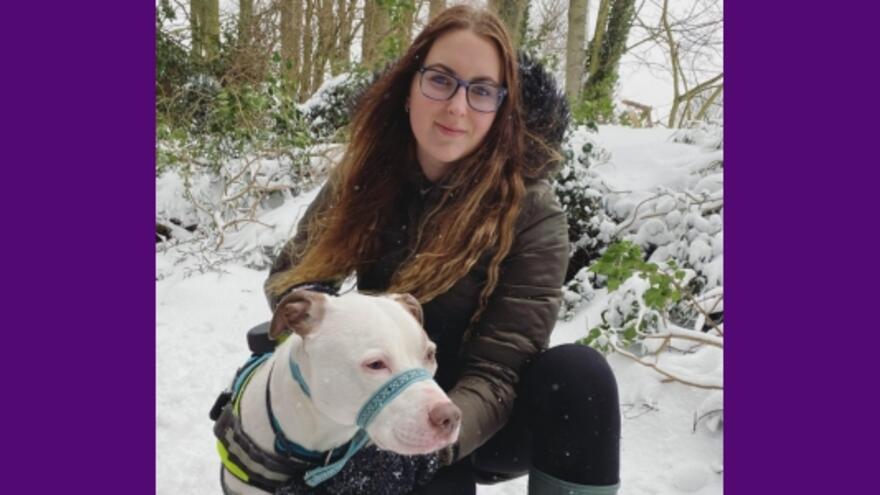 Myth Buster Jessica-Jane is next to her dog in a snowy woodland