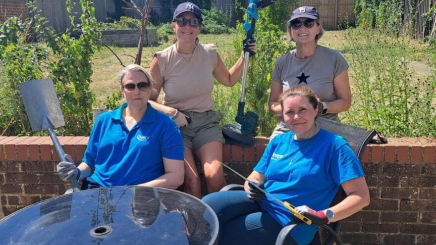 Four people smiling in a garden
