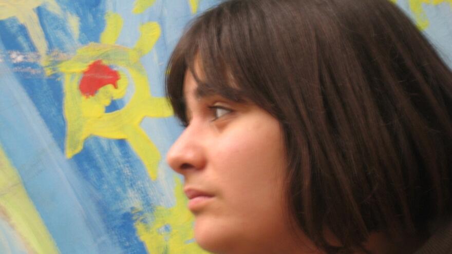 Tara next to a piece of her artwork