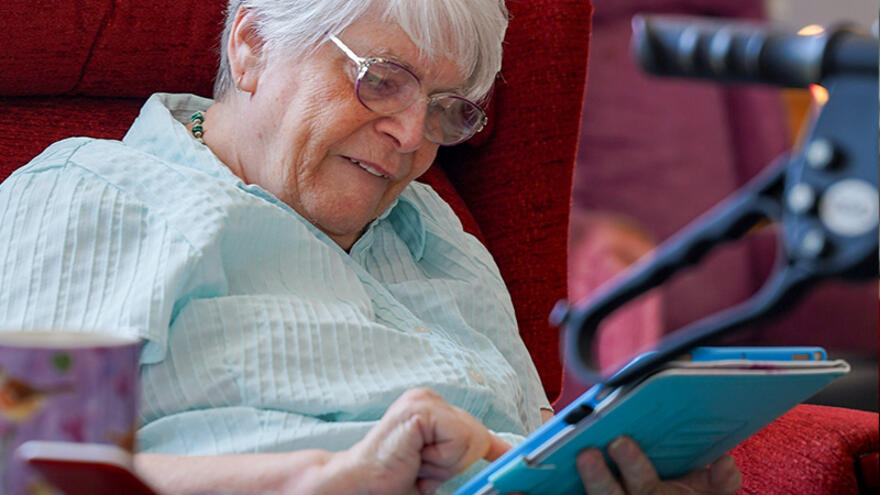 A woman reading and using an iPad
