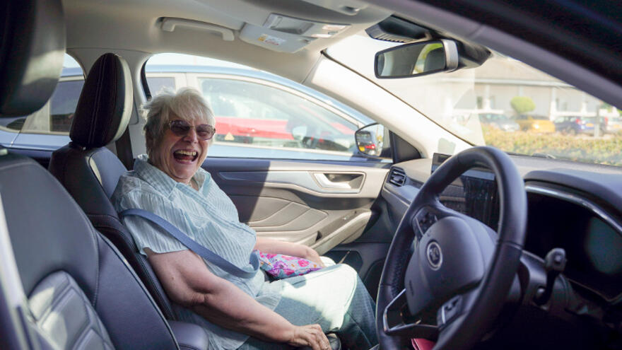 A woman sitting in the passenger seat of a car