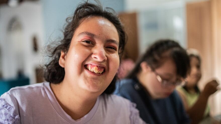 A woman smiling at the camera