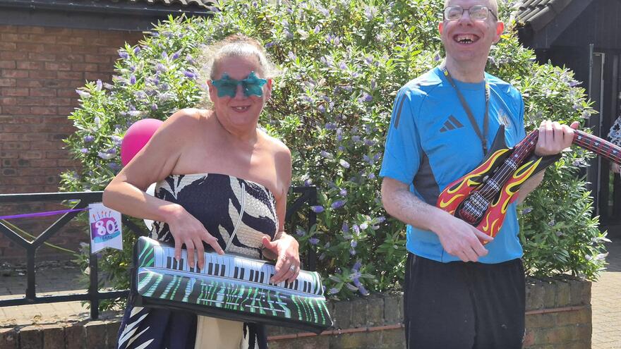 Darren and Tracey, from Mencap's McIntyre Road Service, playing with instruments
