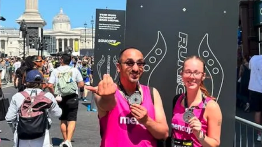 two Mencap runners with their medals after the race