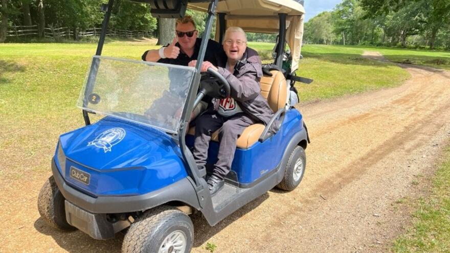 Two men in a golf cart
