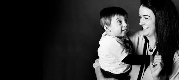 Black and white photograph of woman holding her young son.