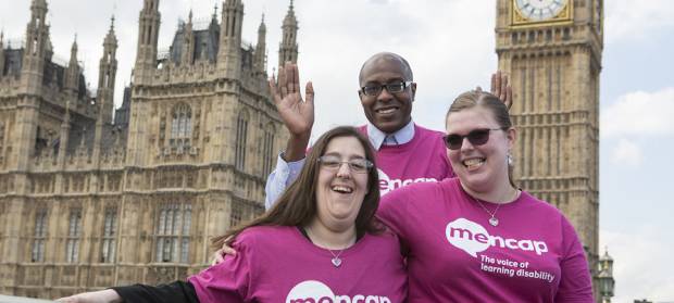 Group of people stood wearing Mencap t-shirts in front of Houses of Parliament and Big Ben