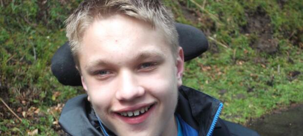 Young man smiling into camera.