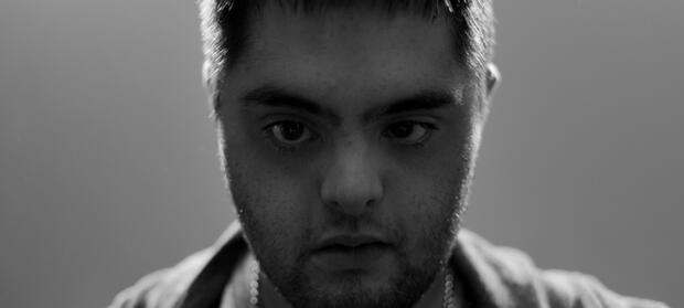 Man stood close to camera looking into lens