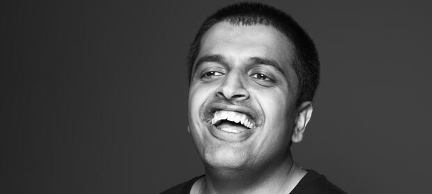 Black and white photo of young man's face, laughing.