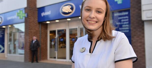Young lady stood in front of Boots store