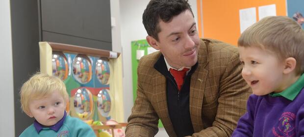 Rory McIlroy sat at table with two children, laughing